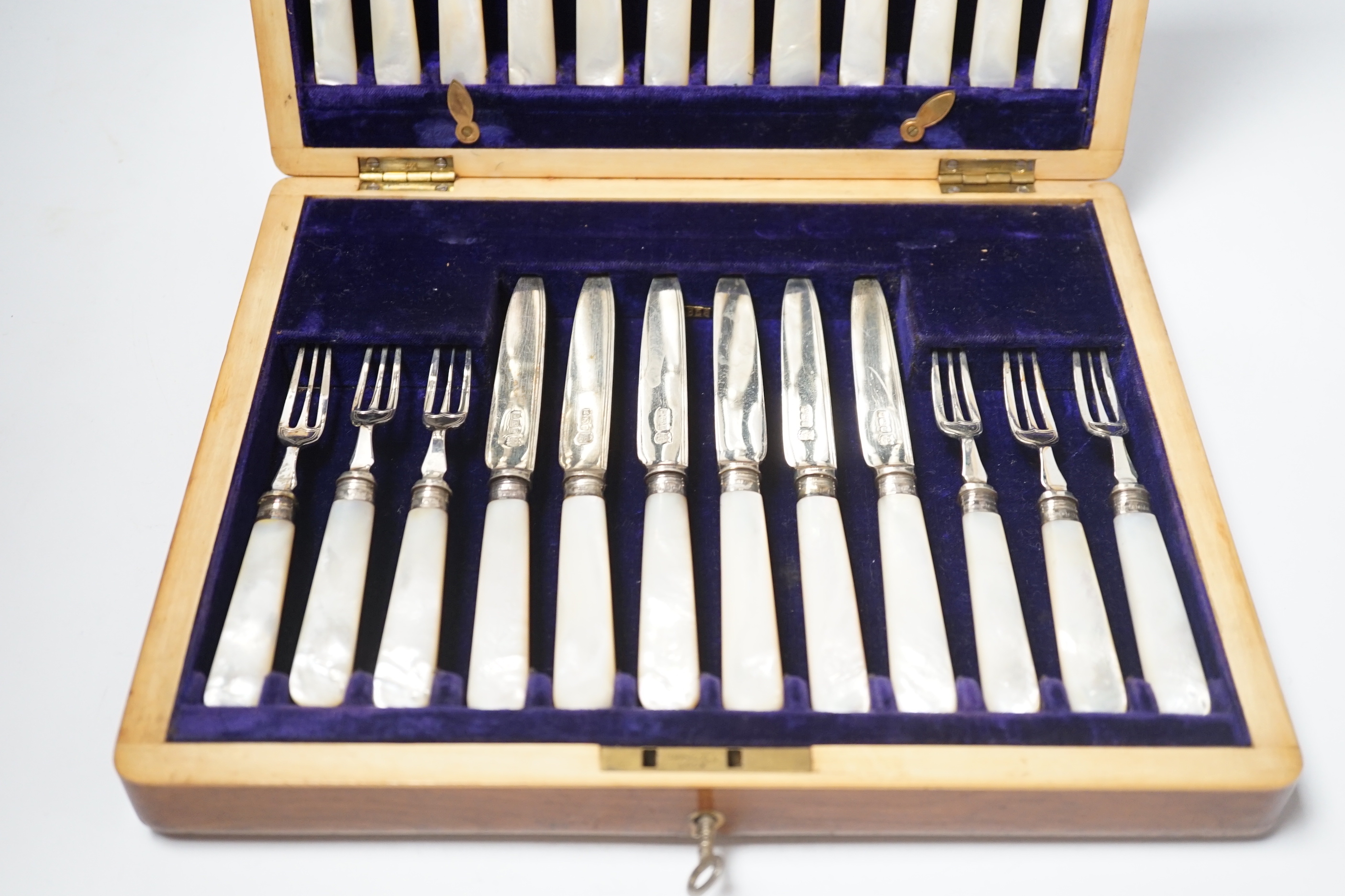 An Edwardian cased set of twelve pairs of silver and mother of pearl handled dessert eaters, Frederick C. Asman & Co, Sheffield, 1905, box 29.2cm.